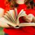 detail from a woman reading a book. Closeup of a woman holding a old book outdoors. woman holding a book behind a nature backgraund. Female hands holding an old book. woman reading a book